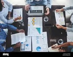 "Team discussing digital marketing plans with charts and laptop."